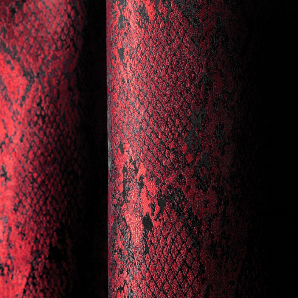 Close-up of red Kvadrat Sahco Ozi upholstery fabric showing rich woven texture and depth