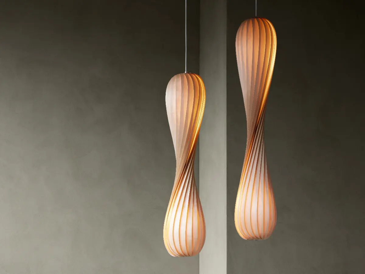 Tom Rossau TR7 pendants hanging on from the ceiling with a mottled contemporary background