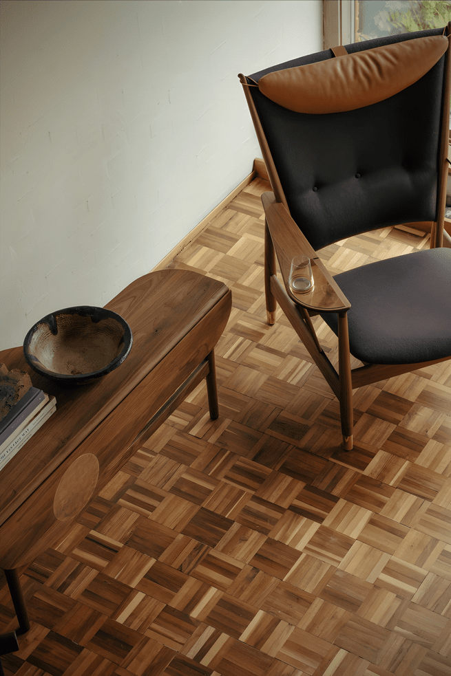 House of Finn Juhl Whisky Chair in dark chocolate leather, shown with its sculptural walnut frame.